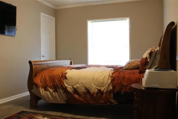 a bedroom with a bed and flat screen tv