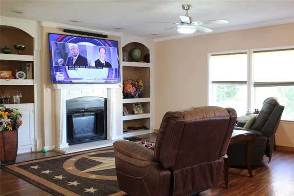 a living room with furniture fireplace and window