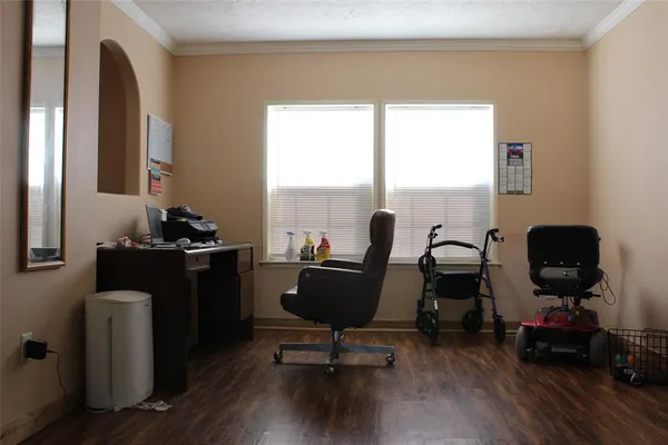 a view of a workspace with furniture and a window