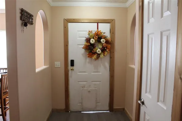 a view of a hallway with wooden floor and closet