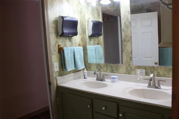 a bathroom with a double vanity sink and a mirror