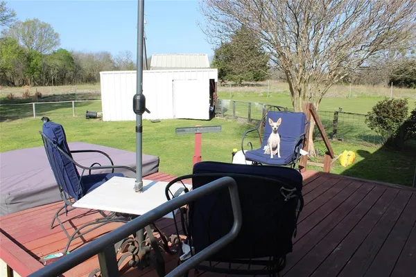 a view of a chairs and table on the deck