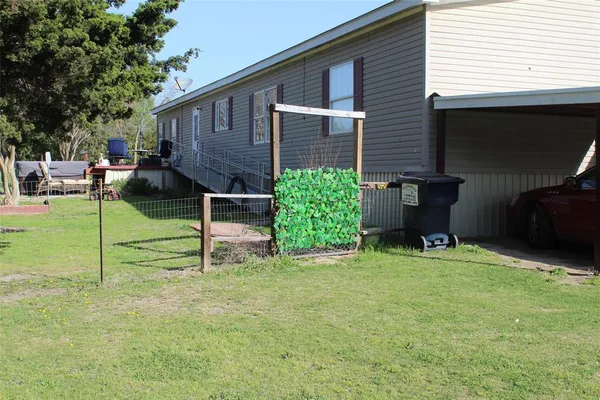a view of house with backyard and seating area