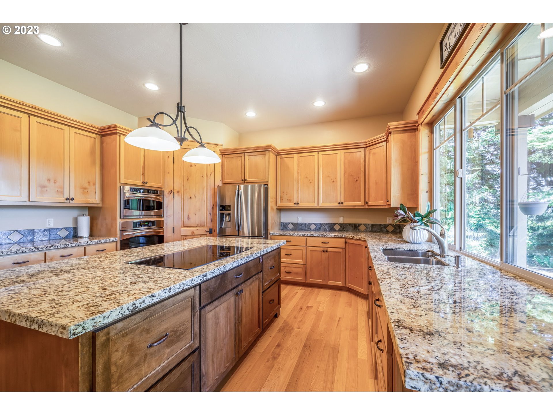 40091 Deerhorn Road Springfield, OR 97478 - Photo 15 of 46 a kitchen with a stove a sink and a wooden cabinets
