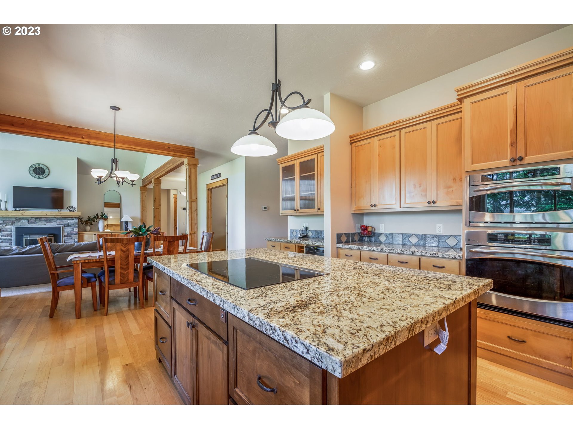 40091 Deerhorn Road Springfield, OR 97478 - Photo 21 of 46 a kitchen with stainless steel appliances granite countertop a sink a stove counter space and living room view