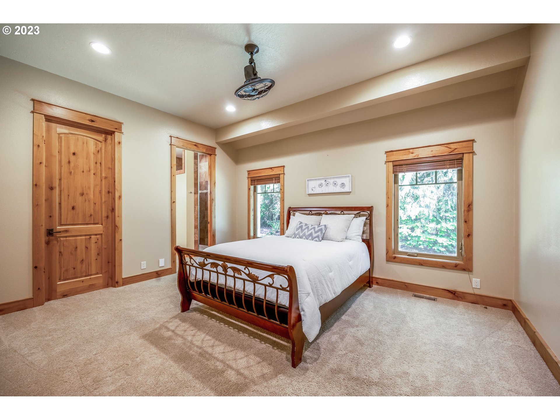 40091 Deerhorn Road Springfield, OR 97478 - Photo 33 of 46 a bedroom with a large bed and a chandelier