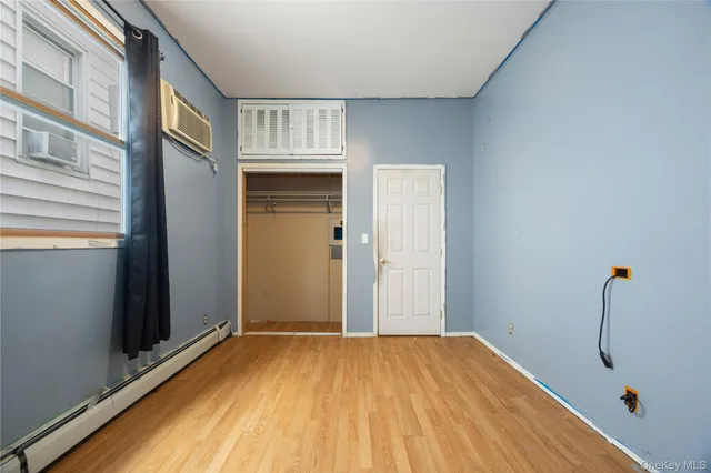a view of a livingroom with wooden floor and staircase