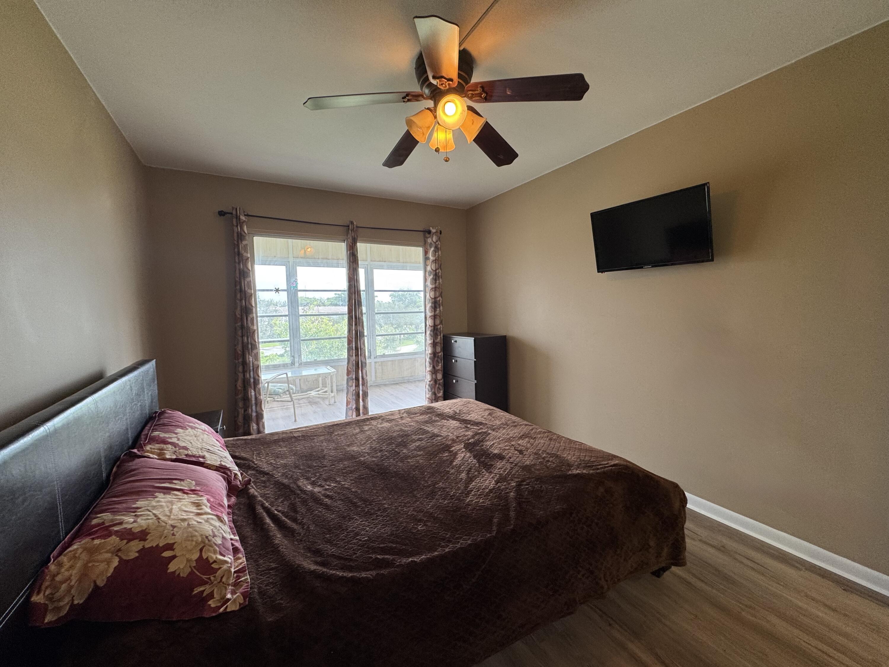 4019 Lincoln A Boca Raton, FL 33434 - Photo 24 of 36 a bedroom with a bed and a flat screen tv