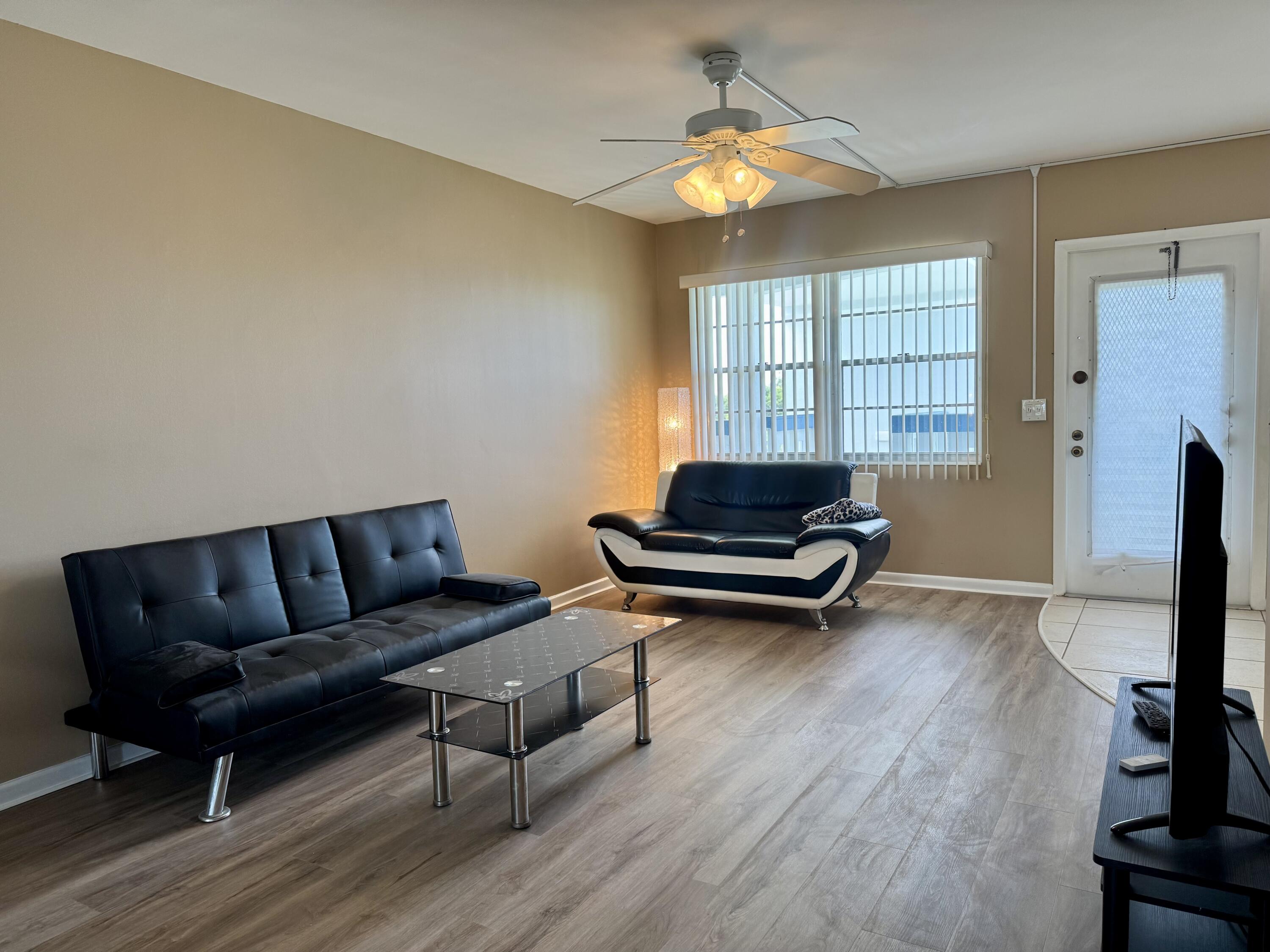 4019 Lincoln A Boca Raton, FL 33434 - Photo 3 of 36 a living room with furniture and a table