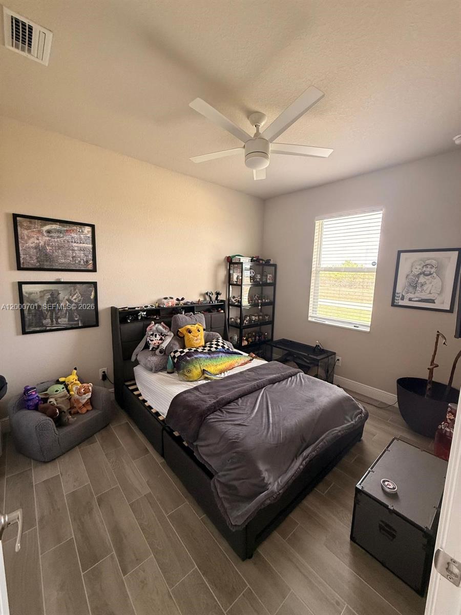 368 Neighborly Road LaBelle, FL 33935 - Photo 11 of 23 a bedroom with a bed and dresser