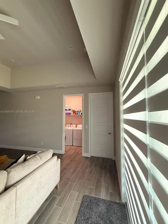a view of a hallway with wooden floor