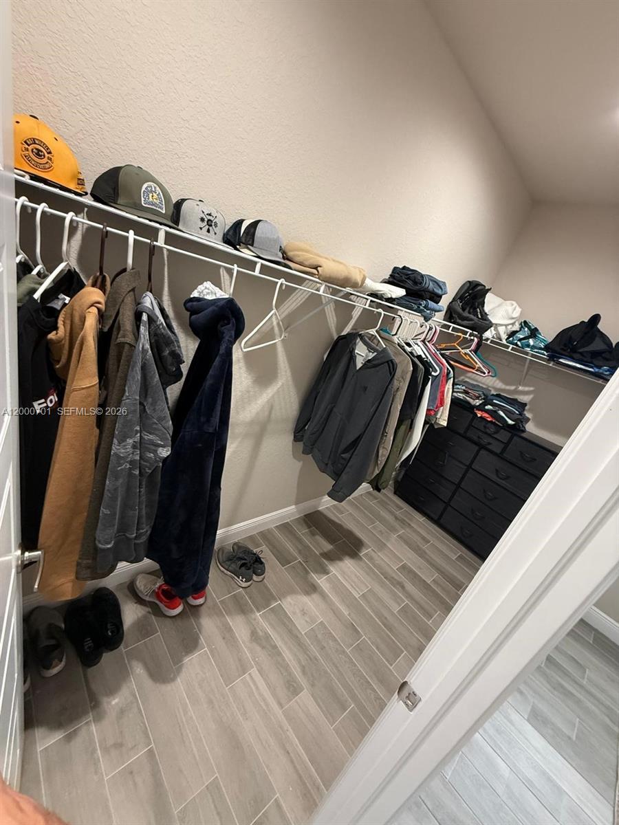 368 Neighborly Road LaBelle, FL 33935 - Photo 19 of 23 a view of walk in closet with clothes and shoes