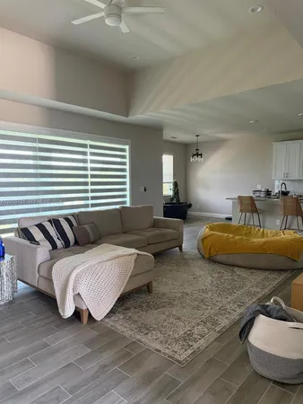 a living room with furniture and a wooden floor