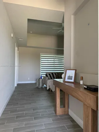 a room with a table chairs and wooden floor