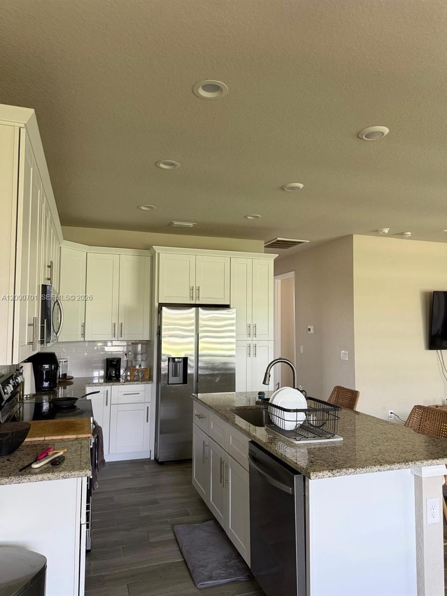 368 Neighborly Road LaBelle, FL 33935 - Photo 7 of 23 a kitchen with a sink stove and cabinets