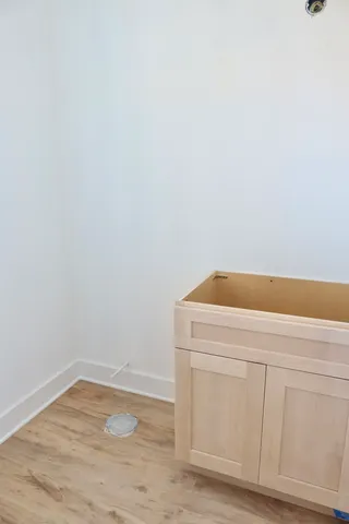 a utility room with wooden floor