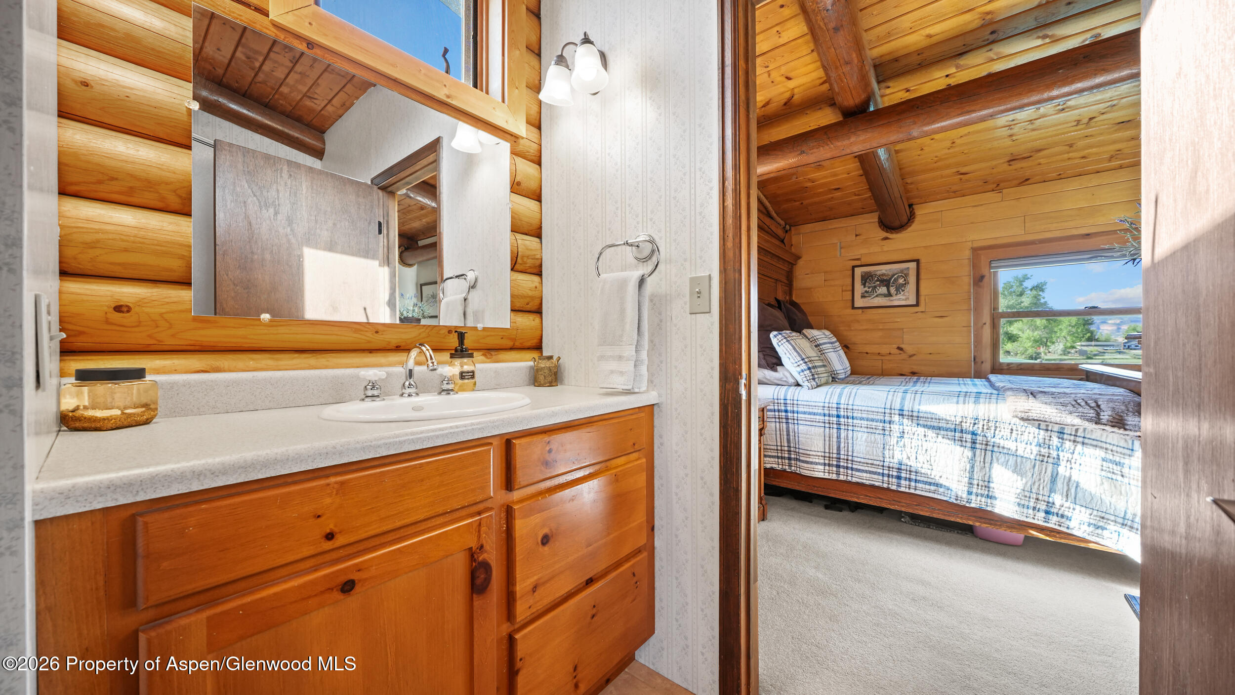 1355 N Road Loma, CO 81524 - Photo 32 of 51 a bathroom with a sink a mirror and next to a window
