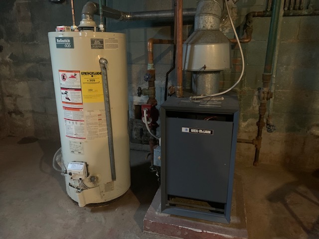 321 East Washington Street Ottawa, IL 61350 - Photo 13 of 20 a room with water heater and storage racks