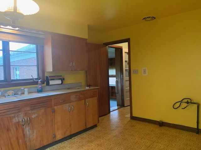 321 East Washington Street Ottawa, IL 61350 - Photo 6 of 20 a kitchen with a sink and cabinets