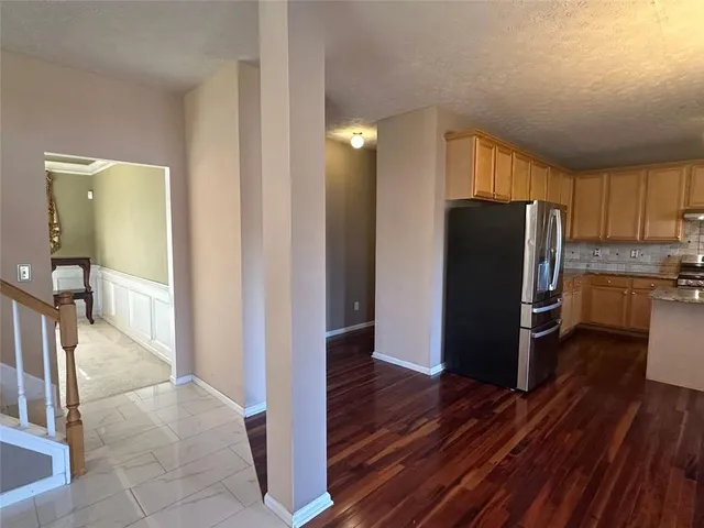 a bathroom with a sink a toilet a mirror and shower
