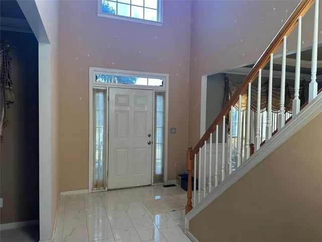 a view of a hallway with wooden floor and closet