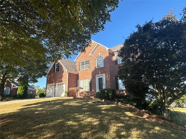 a view of a street with a house in the background