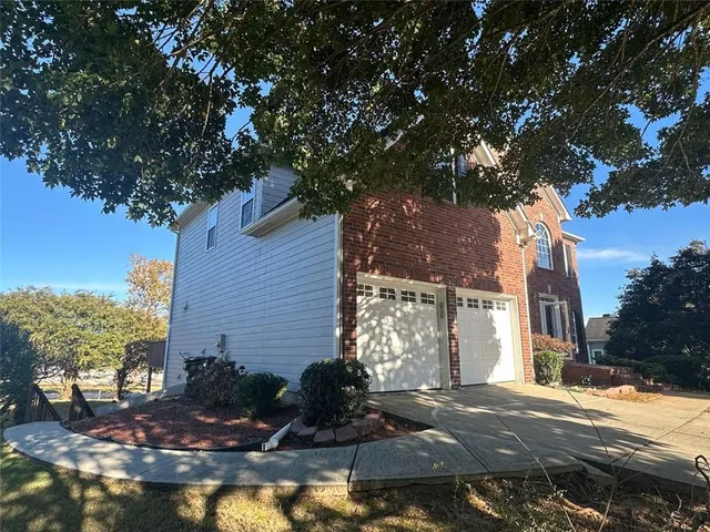 a view of a house with a tree in front