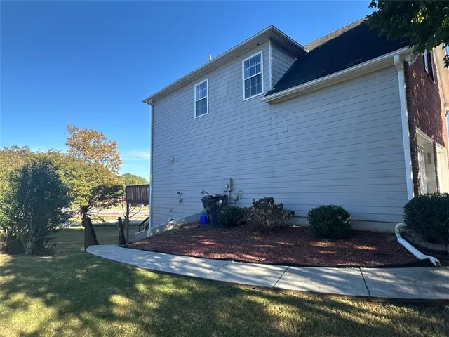 a view of a backyard with plants and a fountain