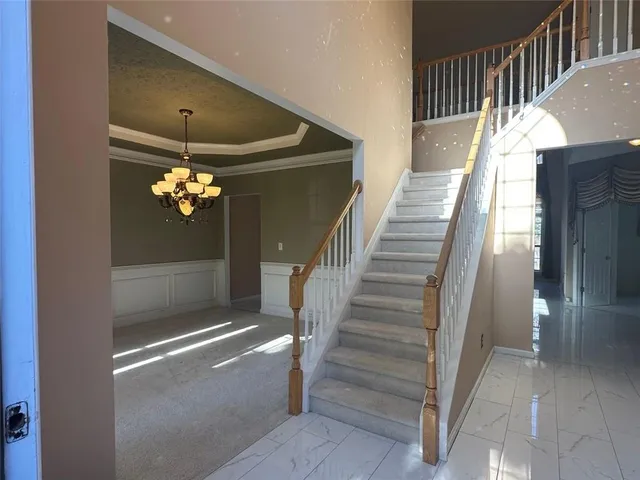 a view of a livingroom with stairs and furniture