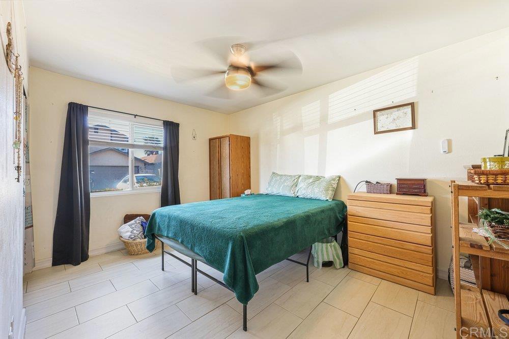 10385 Seth Way Santee, CA 92071 - Photo 24 of 33 a bedroom with a bed and a chandelier