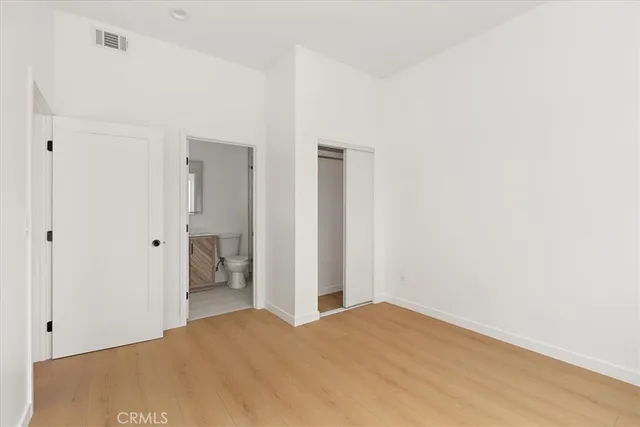 a bathroom with a toilet sink a shower and mirror