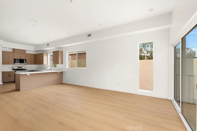 a kitchen with stainless steel appliances granite countertop a refrigerator a stove top oven a sink and dishwasher