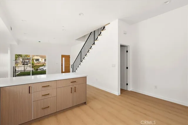 a bathroom with a granite countertop toilet sink and mirror
