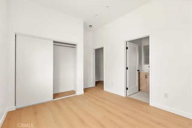 a kitchen with stainless steel appliances a dining table and chairs