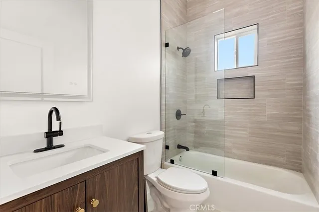 a kitchen with granite countertop a refrigerator stove top oven and sink