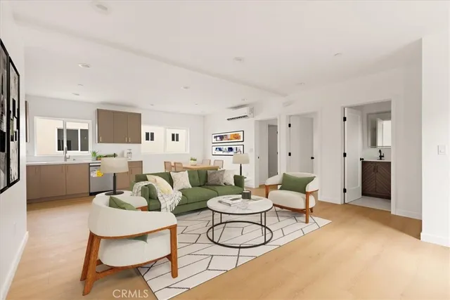 a view of an empty room with wooden floor and windows