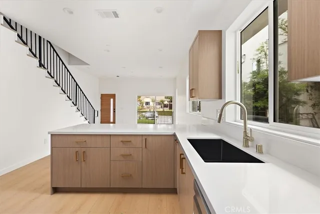 a kitchen with a sink a stove and cabinets