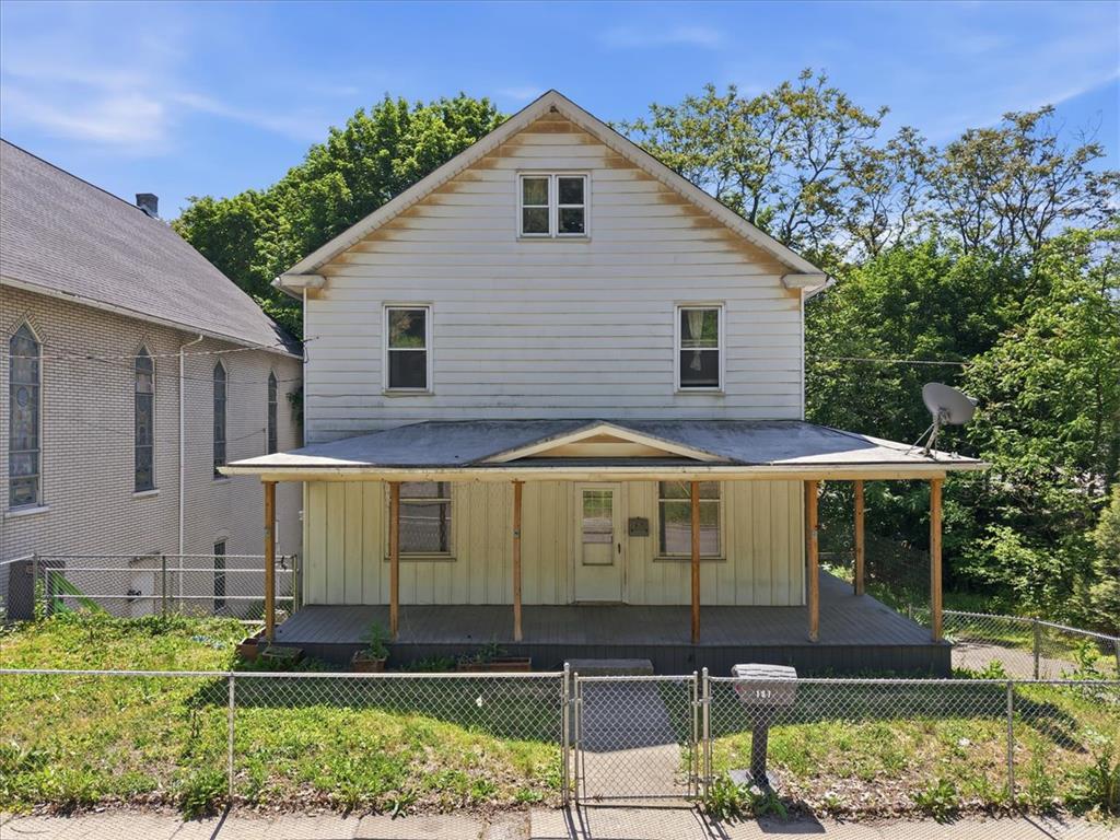 A classic facade with a welcoming covered front porch provides a charming street presence.