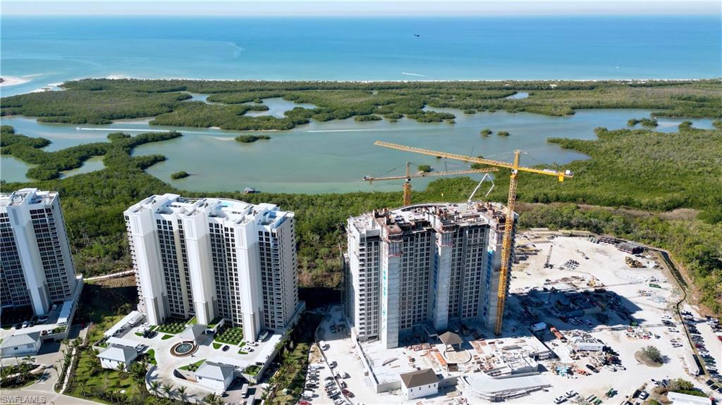 13945 Old Coast Road, Unit PH02 Naples, FL 34110 - Photo 2 of 8 an aerial view of a house with ocean view