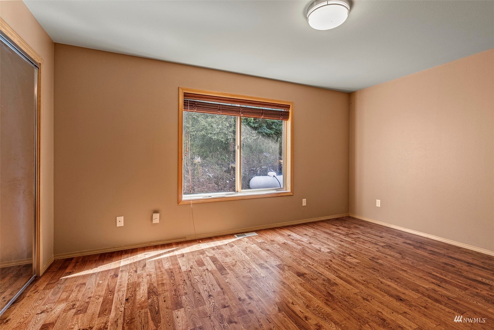 241 Puma Road Longview, WA 98632 - Photo 14 of 24 a view of an empty room with wooden floor and a window