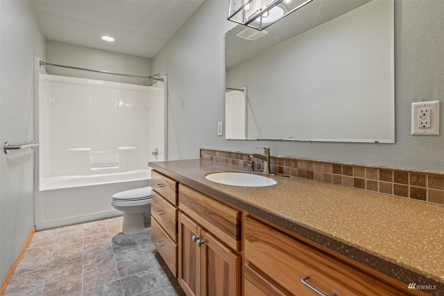 241 Puma Road Longview, WA 98632 - Photo 16 of 24 a bathroom with a granite countertop sink a toilet a mirror and shower