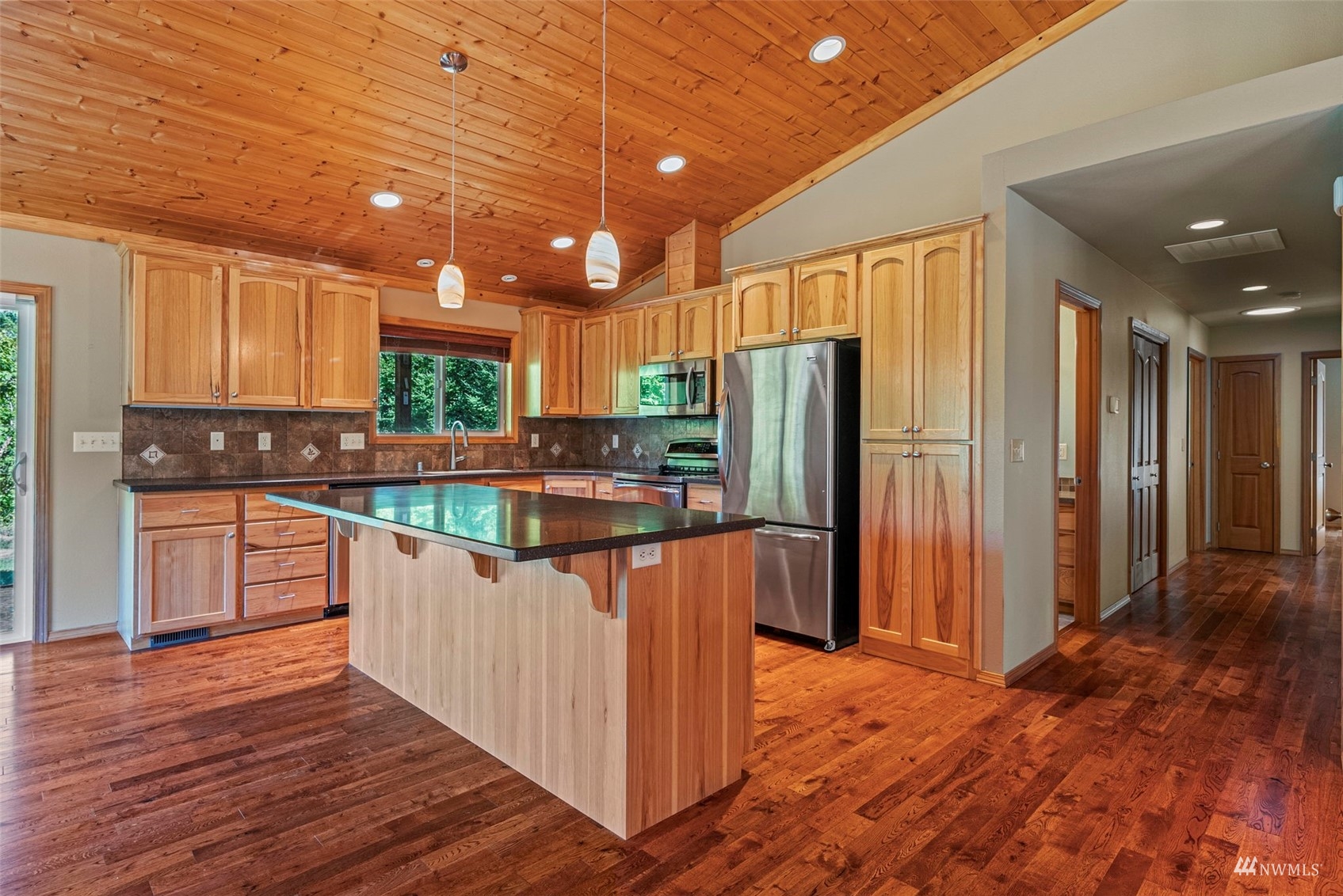 241 Puma Road Longview, WA 98632 - Photo 9 of 24 a kitchen with stainless steel appliances granite countertop a refrigerator a sink dishwasher a stove with wooden cabinets and floor