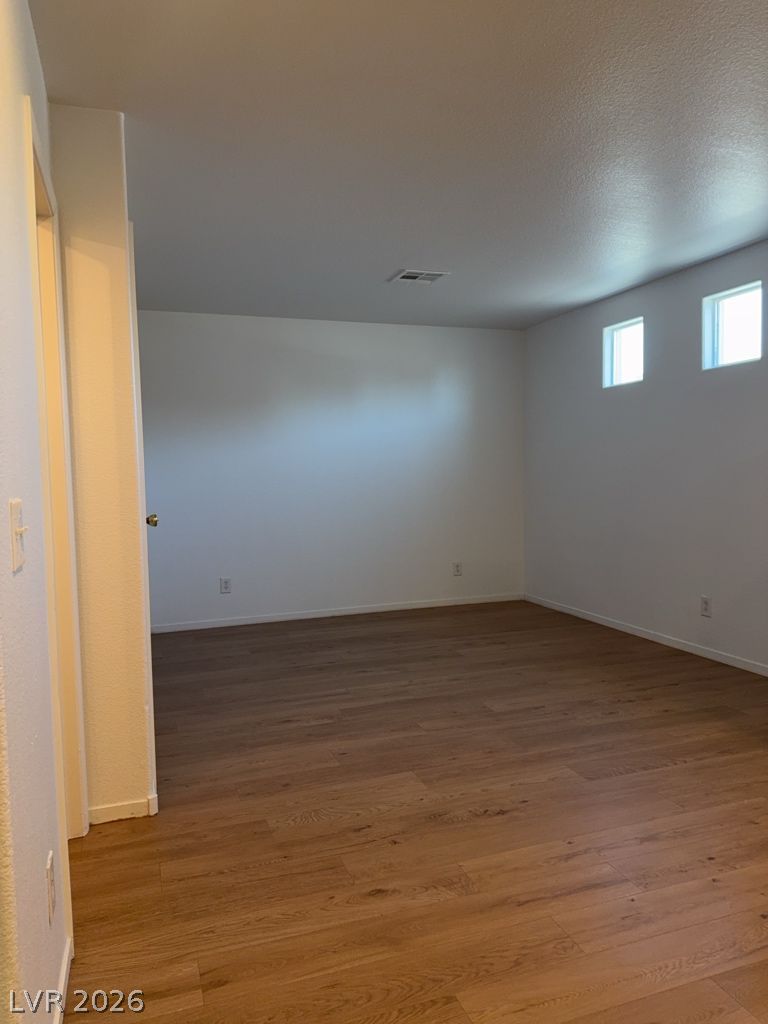4790 Pinon Pointe Road Las Vegas, NV 89115 - Photo 6 of 16 Rich hardwood-style flooring extends across this spacious, naturally illuminated room.