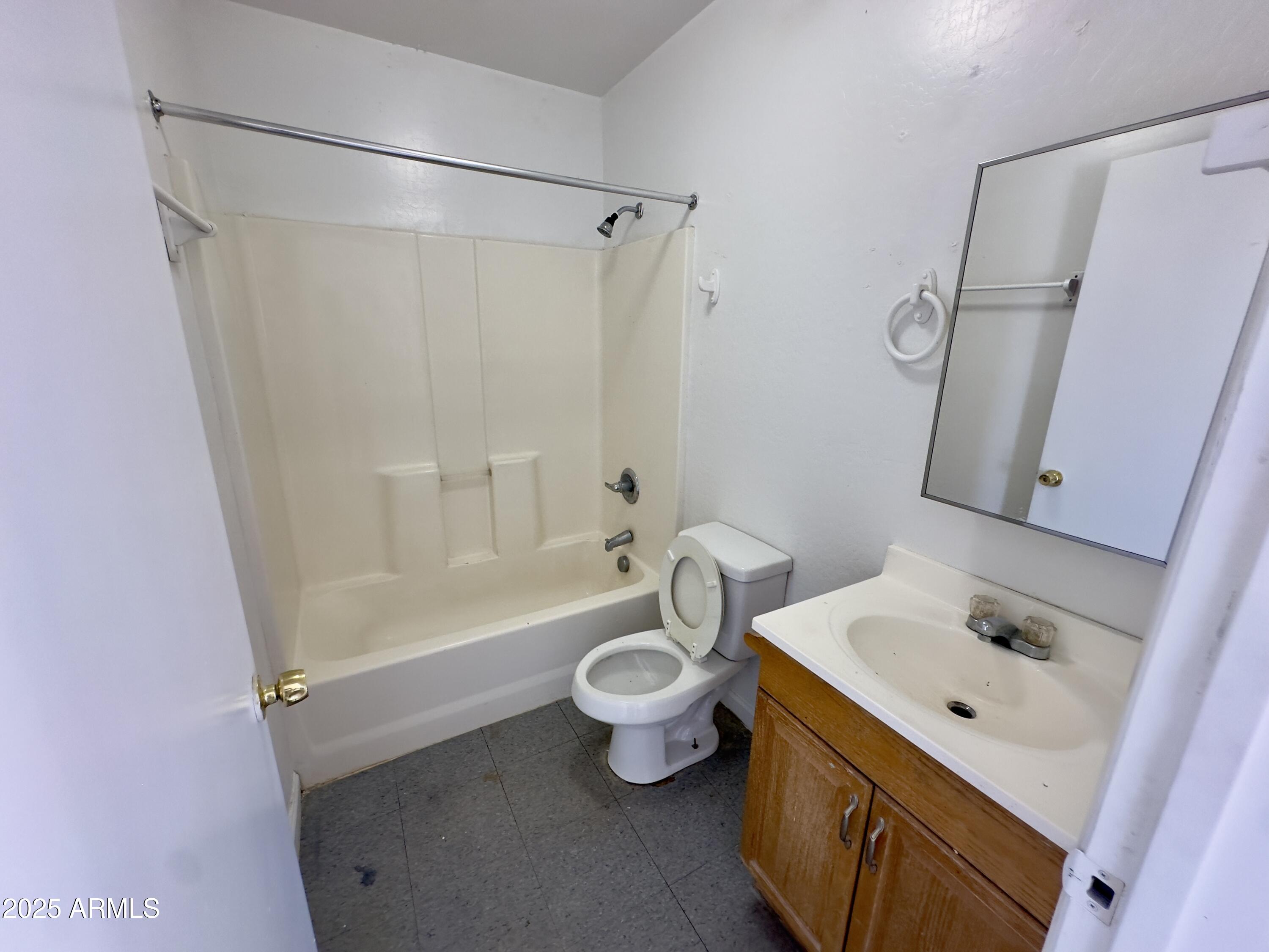 1224 East Apache Street, Unit 2 Phoenix, AZ 85034 - Photo 15 of 17 a bathroom with a sink a toilet and shower