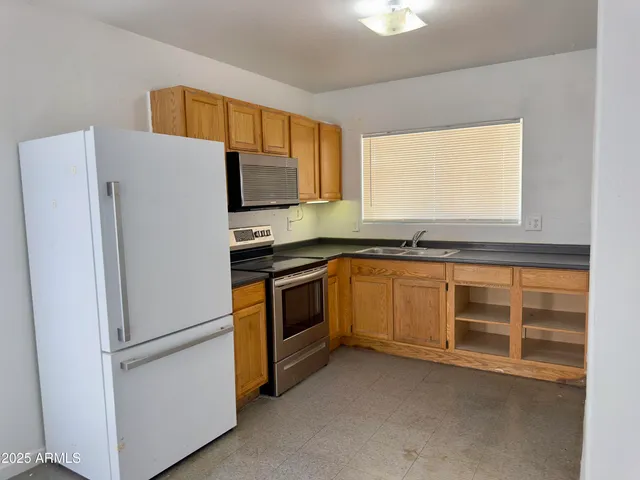 a white refrigerator freezer sitting inside of a kitchen