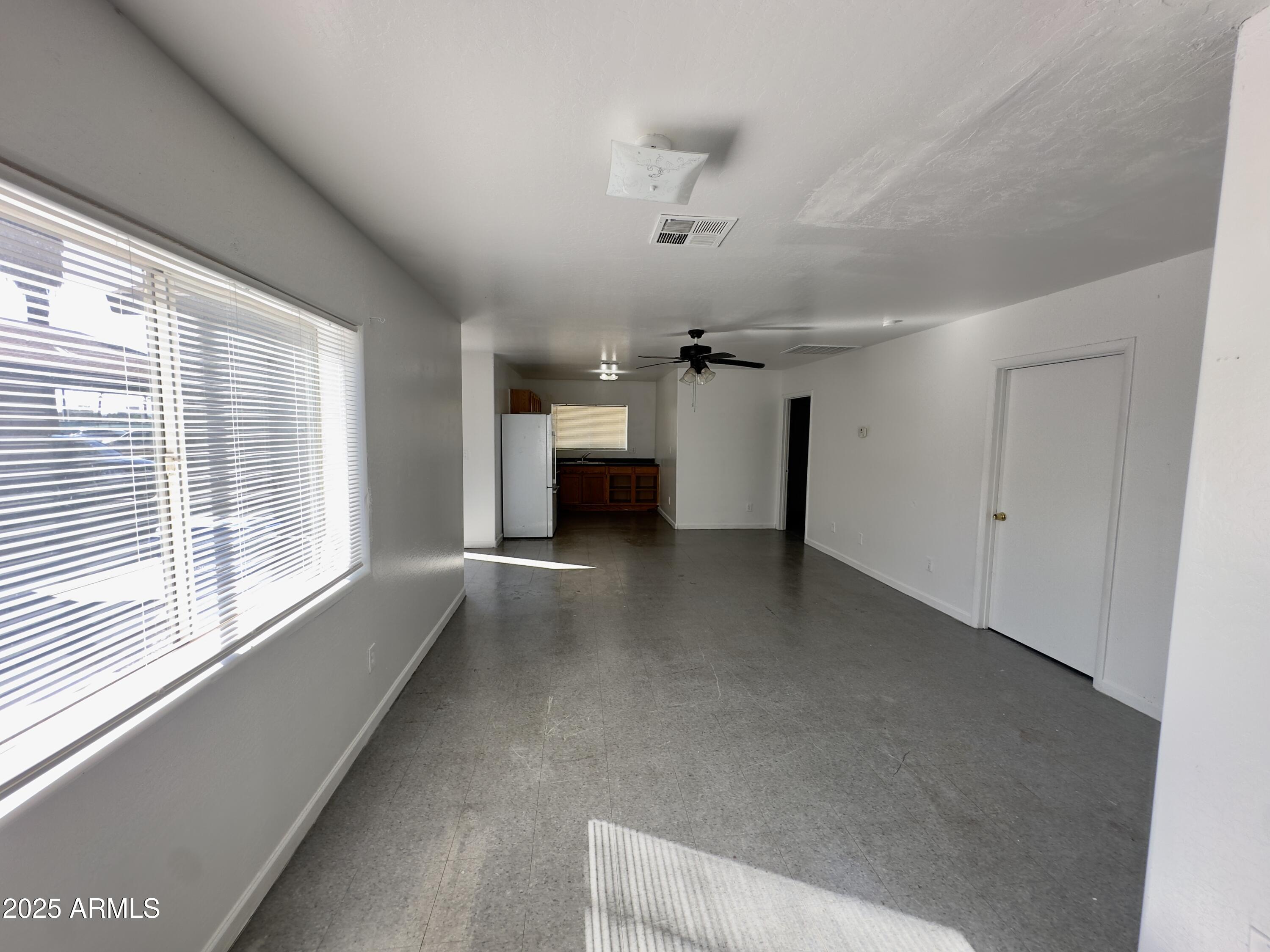 1224 East Apache Street, Unit 2 Phoenix, AZ 85034 - Photo 5 of 17 a view of a livingroom with a ceiling fan and window