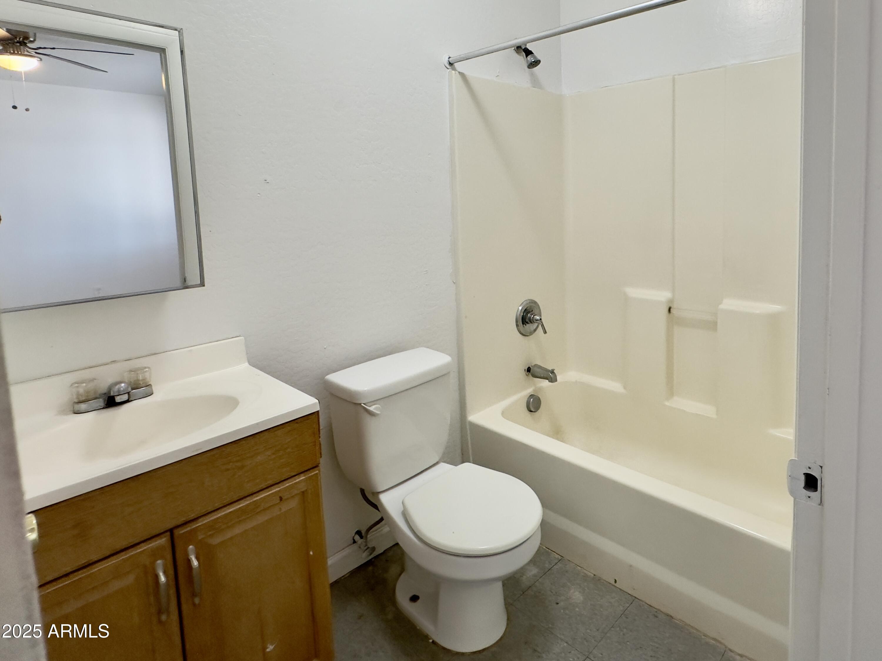 1224 East Apache Street, Unit 2 Phoenix, AZ 85034 - Photo 9 of 17 a bathroom with a sink toilet and shower