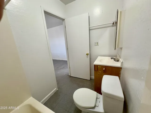 a white toilet sitting next to a bathroom sink