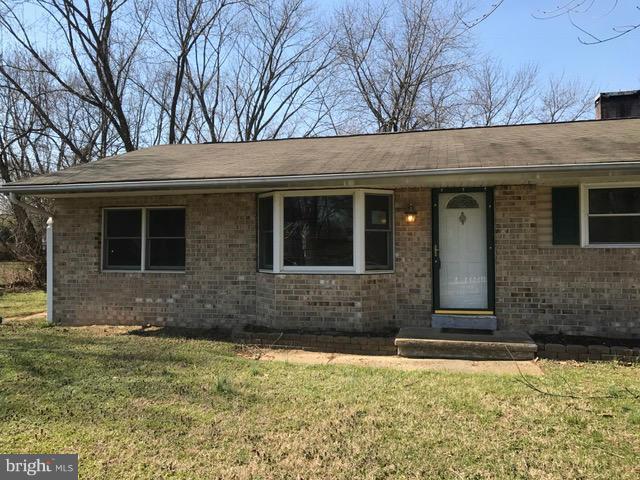 8149 Elizabeth Road Pasadena, MD 21122 - Photo 15 of 18 a front view of a house with a yard