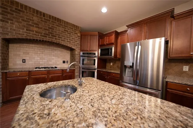 a kitchen with a refrigerator sink and stainless steel appliances